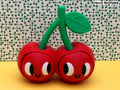3D printed cherry fidget clicker with smiling faces