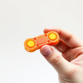 Orange 3D printed fidget slider held in hand